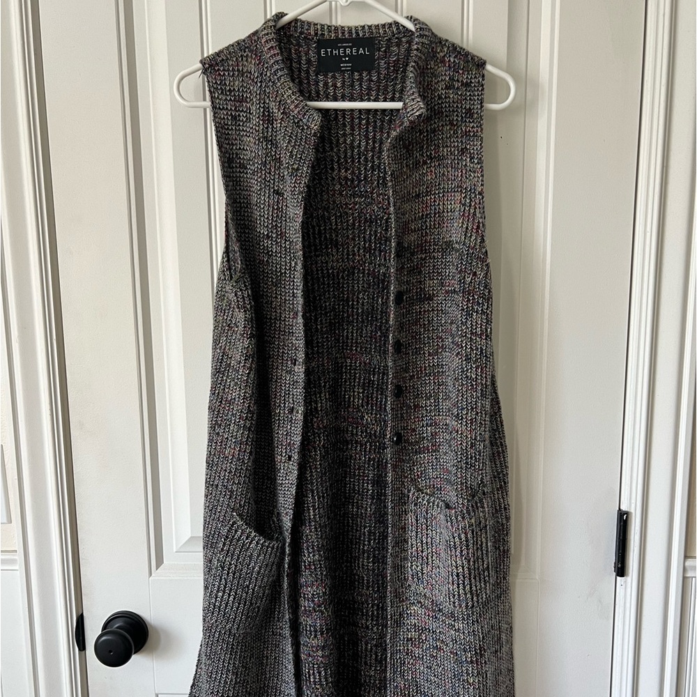 Ethereal long sweater cardigan. Size M. Wool fibers, button closure. Sleeveless.